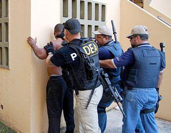 Drug Enforcement Administration agents arrest a suspect