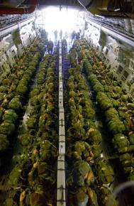 U.S. soldiers from the 82nd Airborne packed into a troop transport plane