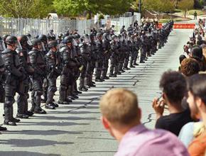 Anti-fascist protesters confront a phalanx of riot police in Newnan
